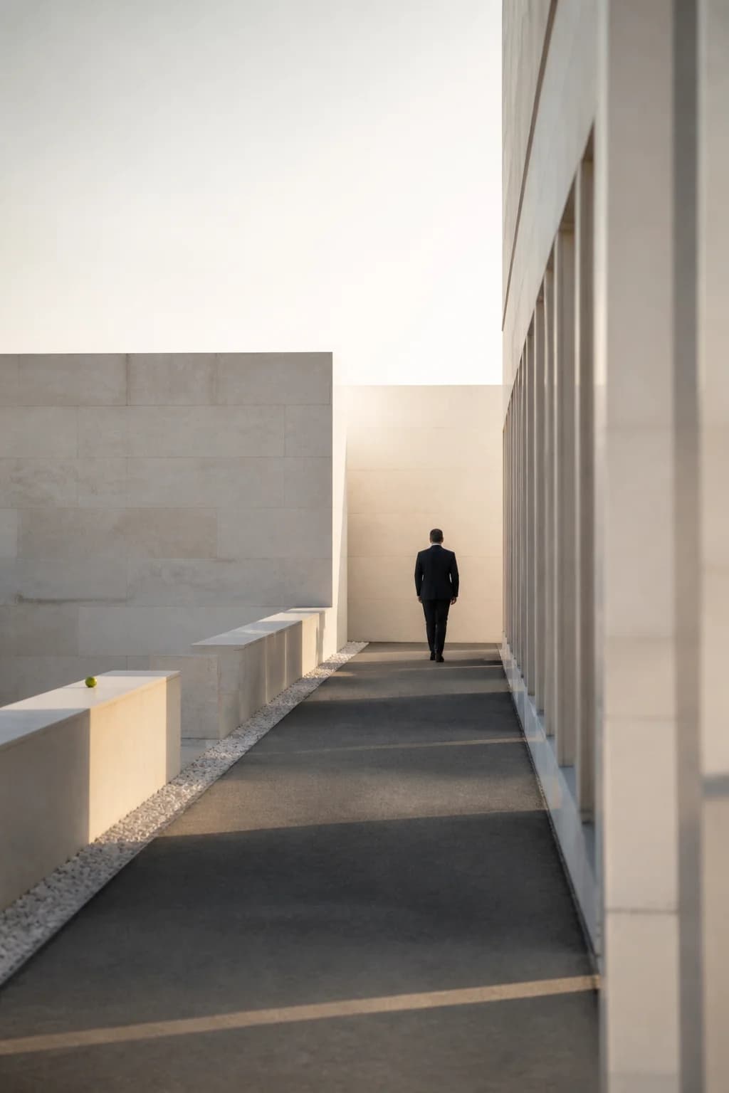 Quiet corridor with a distant figure, vertical crop