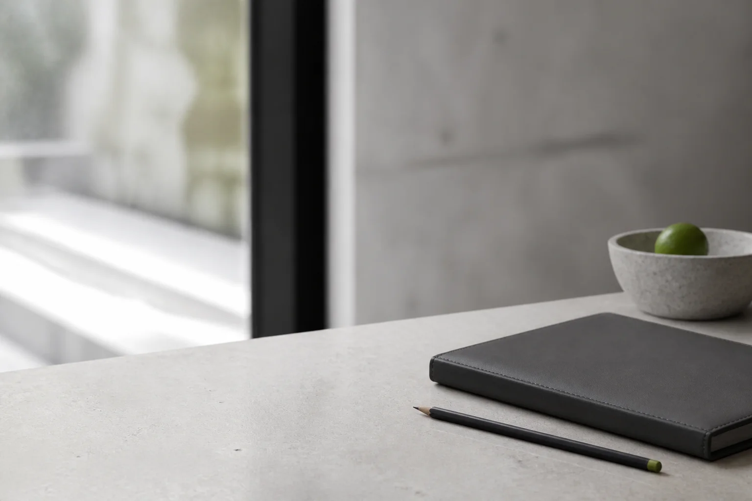 Closed portfolio and pencil on a limestone table